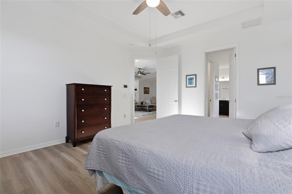 14879 Wichita Road Port Charlotte, FL 33981 - Photo 19 of 45 a bedroom with a bed and a chandelier