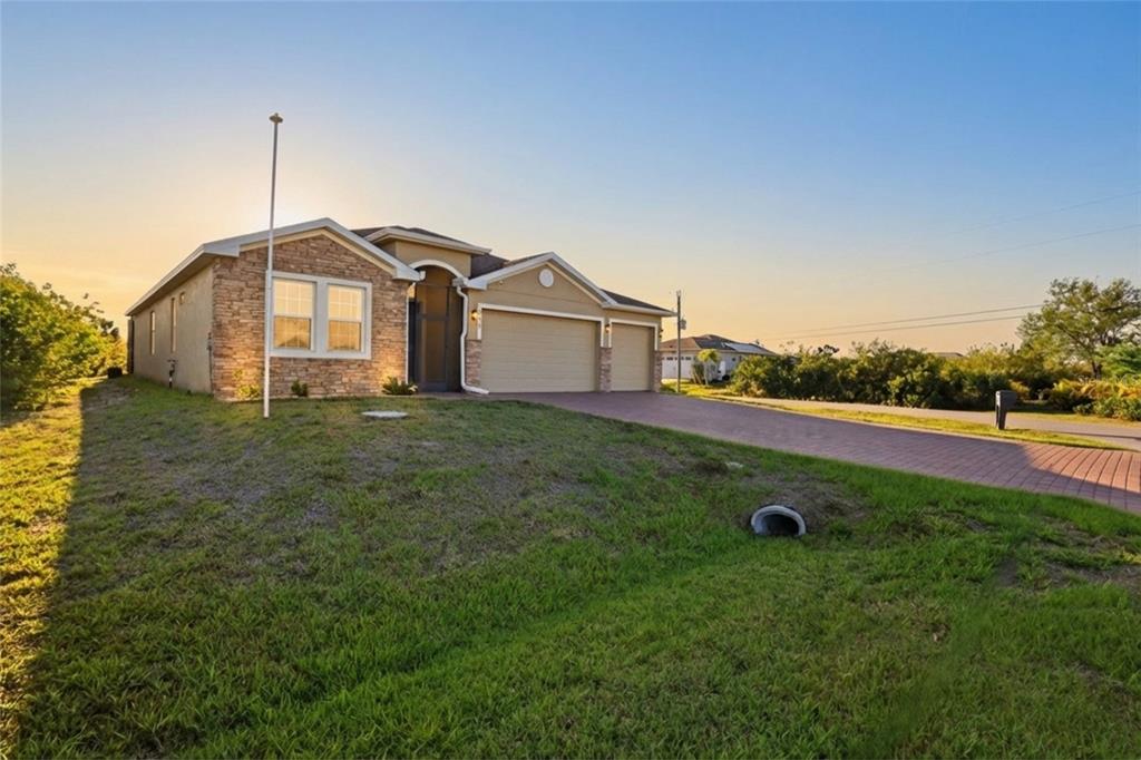 14879 Wichita Road Port Charlotte, FL 33981 - Photo 2 of 45 a front view of a house with yard