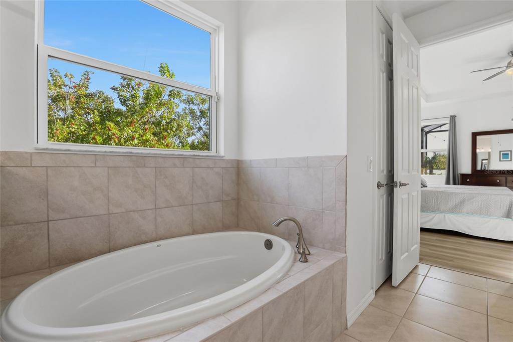 14879 Wichita Road Port Charlotte, FL 33981 - Photo 23 of 45 a bathroom with a tub and shower