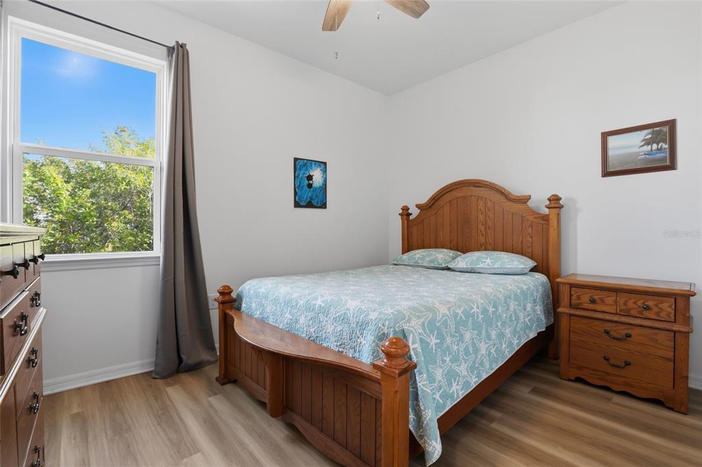 14879 Wichita Road Port Charlotte, FL 33981 - Photo 26 of 45 a bedroom with a bed and wooden floor