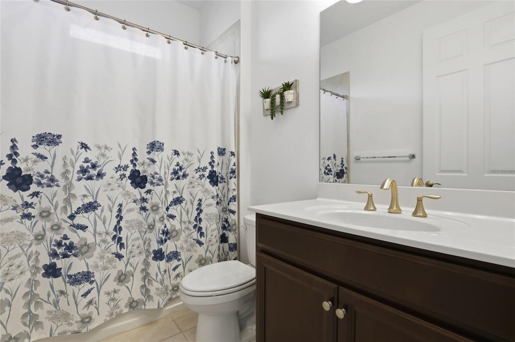 14879 Wichita Road Port Charlotte, FL 33981 - Photo 28 of 45 a bathroom with a granite countertop sink and a toilet