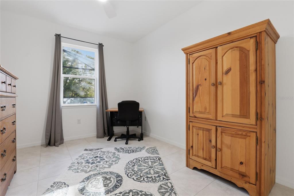 14879 Wichita Road Port Charlotte, FL 33981 - Photo 29 of 45 a bedroom with a bed and a window