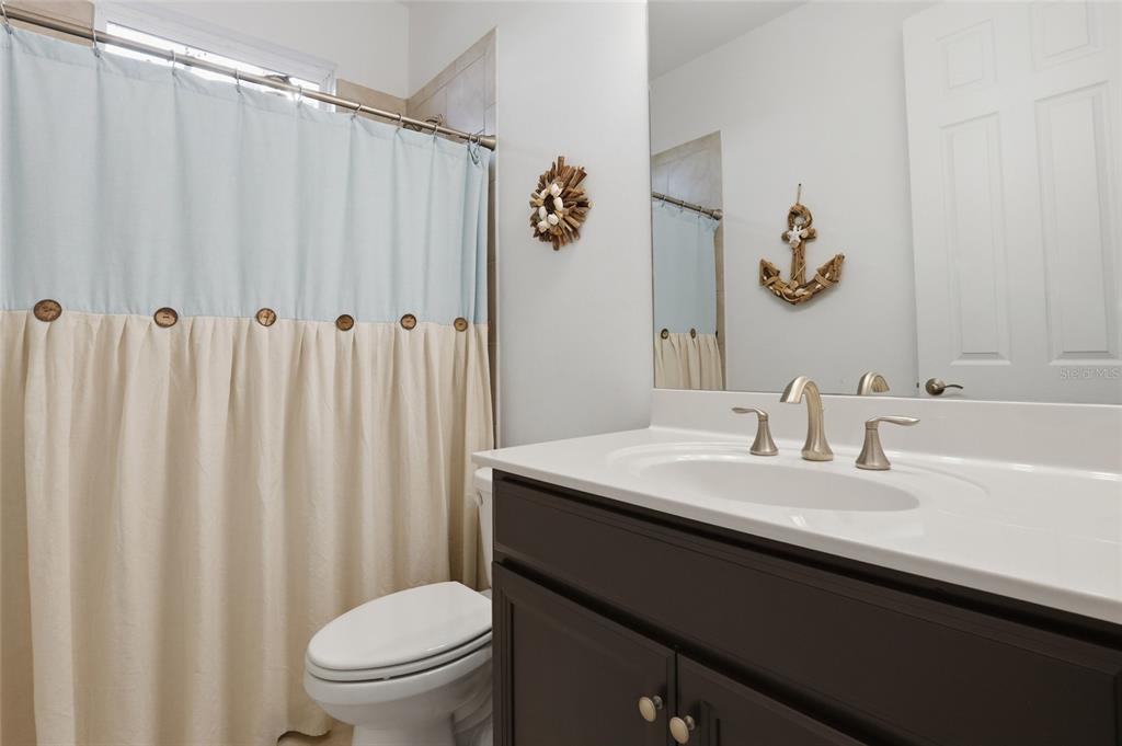 14879 Wichita Road Port Charlotte, FL 33981 - Photo 31 of 45 a bathroom with a sink vanity mirror and toilet
