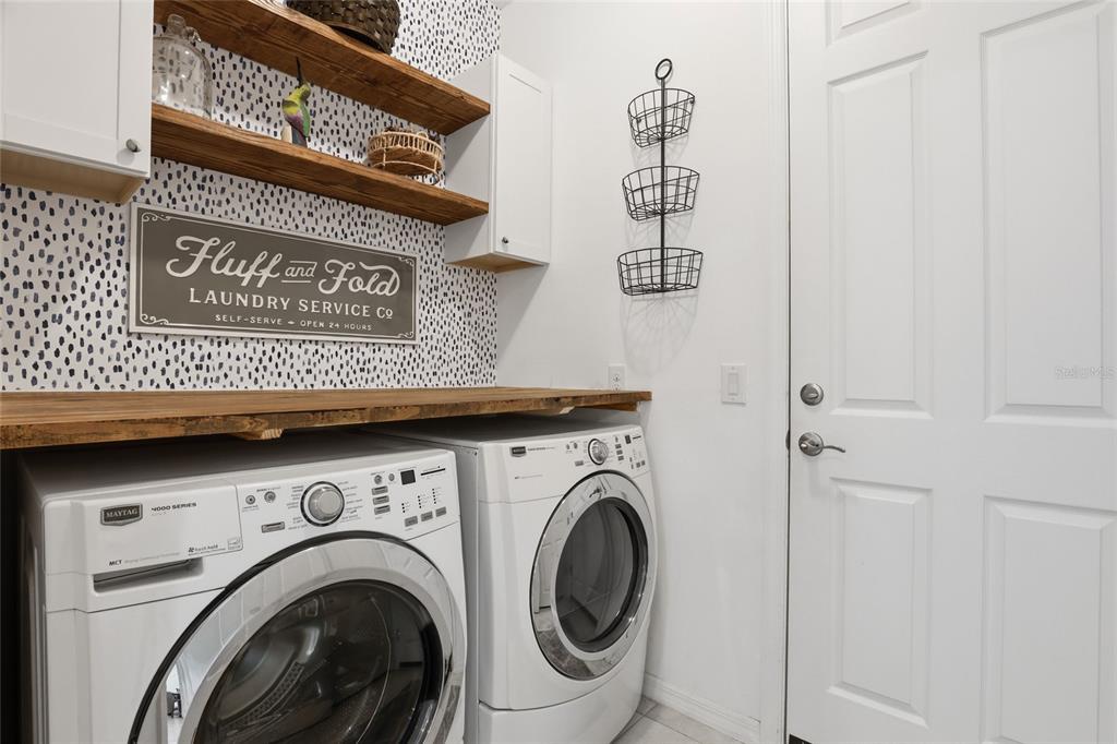 14879 Wichita Road Port Charlotte, FL 33981 - Photo 33 of 45 a view of a hallway with washer and dryer