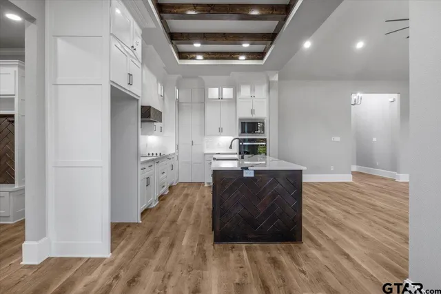 a large room with wooden floor and windows