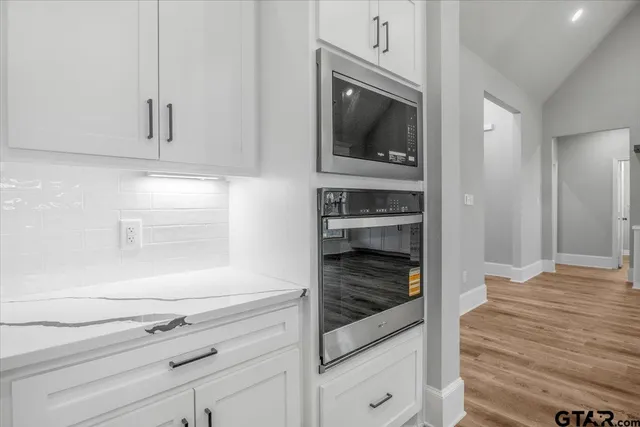 a kitchen with a stove and a microwave