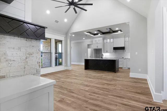 a view of kitchen with sink and refrigerator