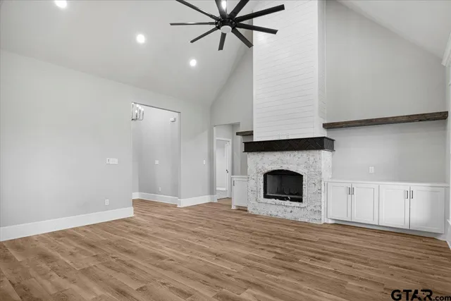 a view of a livingroom with a fireplace and cabinet