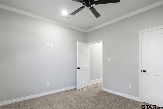 an empty room with an entrance to other room