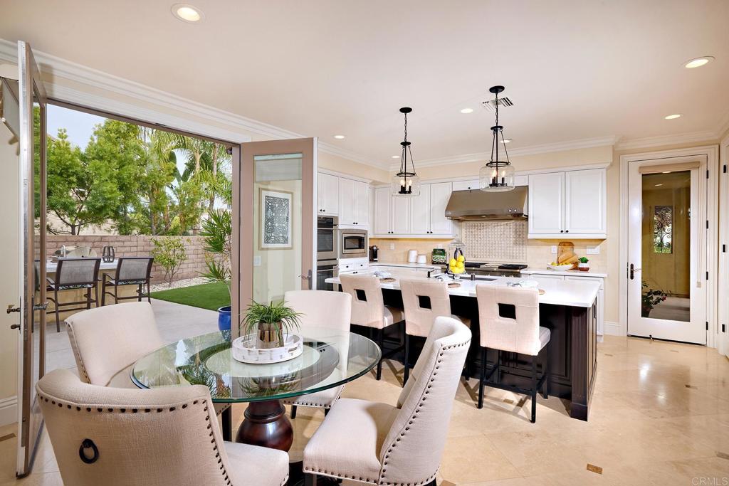 6895 Amber Lane Carlsbad, CA 92009 - Photo 12 of 45 a view of kitchen with stainless steel appliances kitchen island living room dining table and chairs