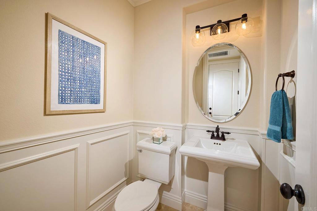6895 Amber Lane Carlsbad, CA 92009 - Photo 19 of 45 a bathroom with a toilet sink and mirror