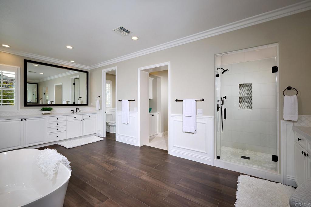 6895 Amber Lane Carlsbad, CA 92009 - Photo 30 of 45 a spacious bathroom with a shower a sink and a mirror