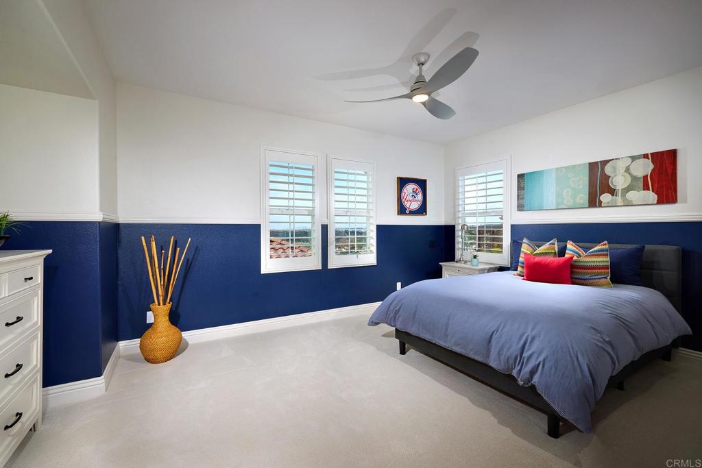 6895 Amber Lane Carlsbad, CA 92009 - Photo 31 of 45 a bedroom with a bed and a chandelier