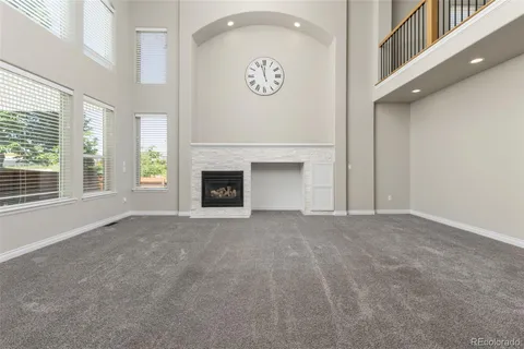a view of empty room with a fireplace