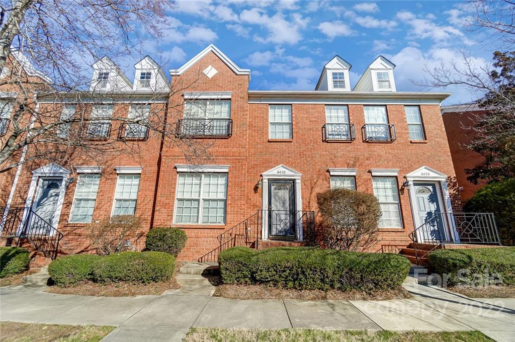 a front view of a residential houses with yard