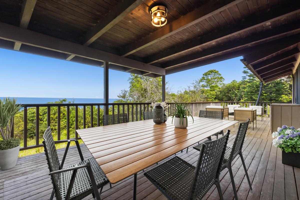 81-6315 Hawaiʻi Belt Road Captain Cook, HI 96750 - Photo 1 of 25 a view of a patio with a table chairs and wooden floor