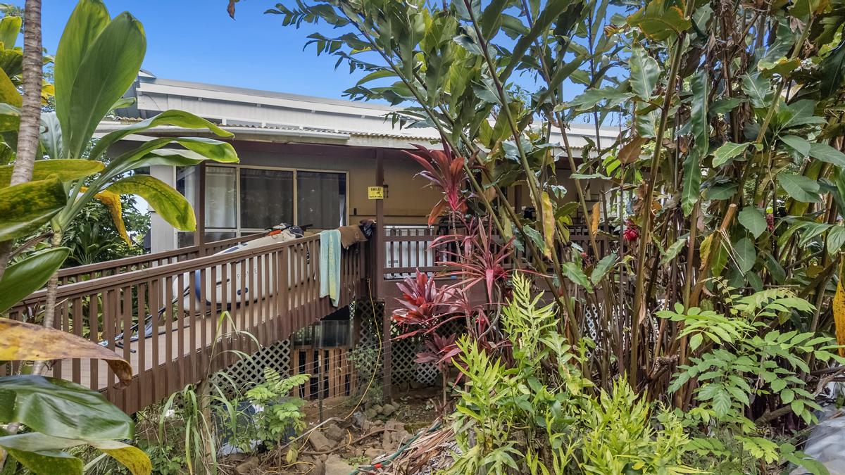 81-6315 Hawaiʻi Belt Road Captain Cook, HI 96750 - Photo 25 of 25 a view of a house with a flower garden