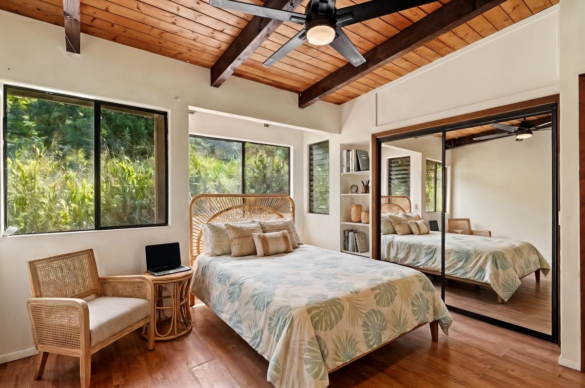 81-6315 Hawaiʻi Belt Road Captain Cook, HI 96750 - Photo 7 of 25 a bedroom with a bed and wooden floor