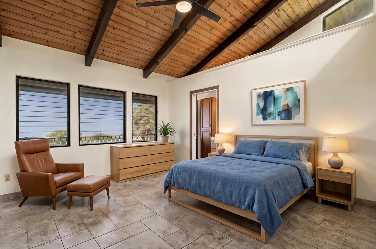 81-6315 Hawaiʻi Belt Road Captain Cook, HI 96750 - Photo 9 of 25 a bedroom with furniture and a large window