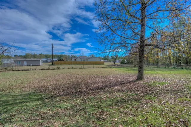 a view of a field with trees