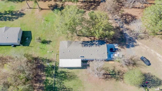 an aerial view of a house with yard