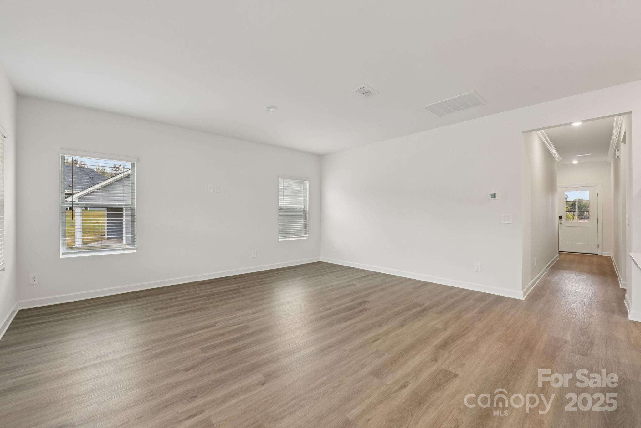 712 Palmer Pendleton Way York, SC 29745 - Photo 5 of 36 a view of an empty room with wooden floor and a window
