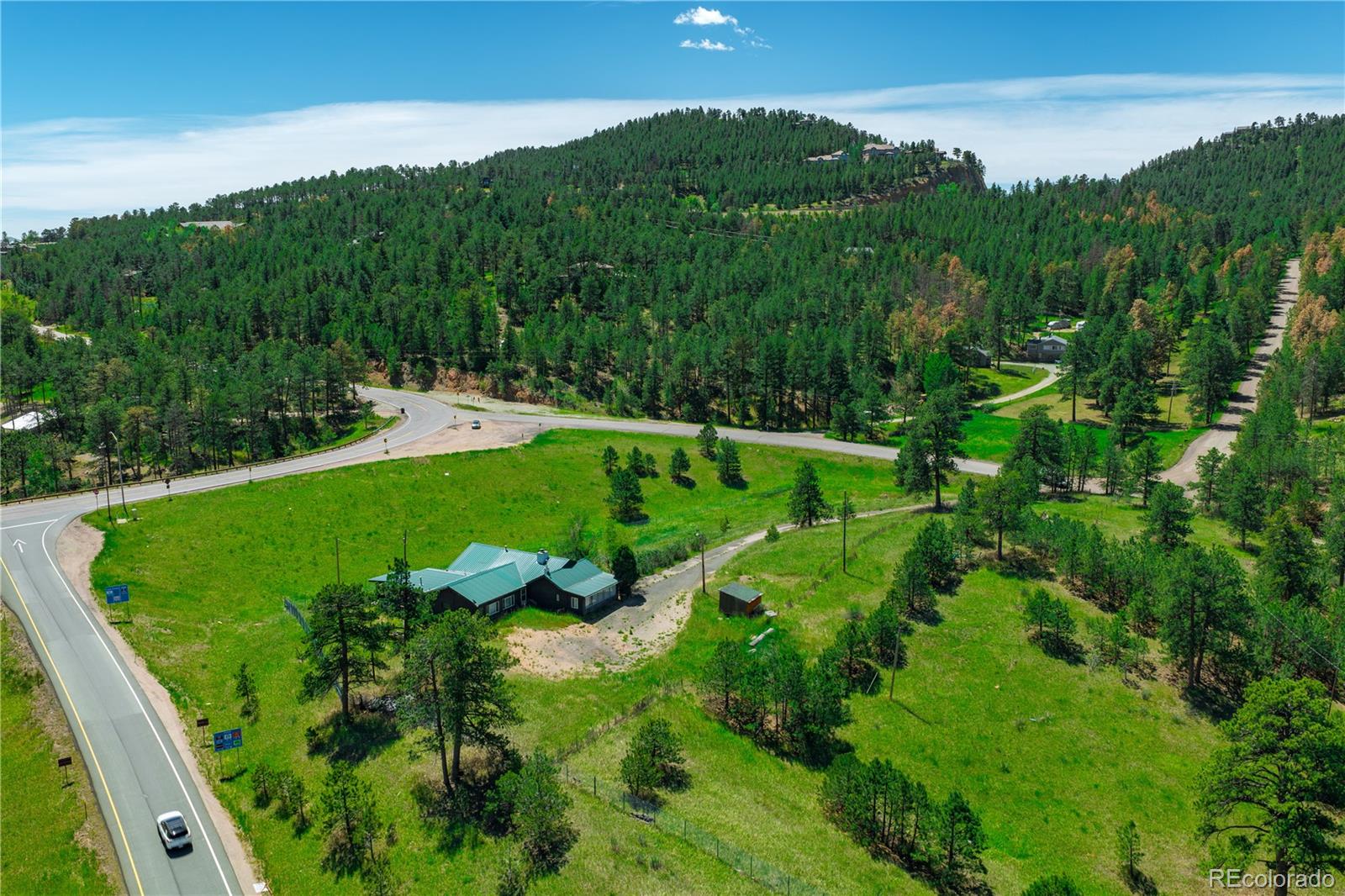 29793 Ruby Ranch Road Evergreen, CO 80439 - Photo 28 of 28 a view of a garden with a building in background
