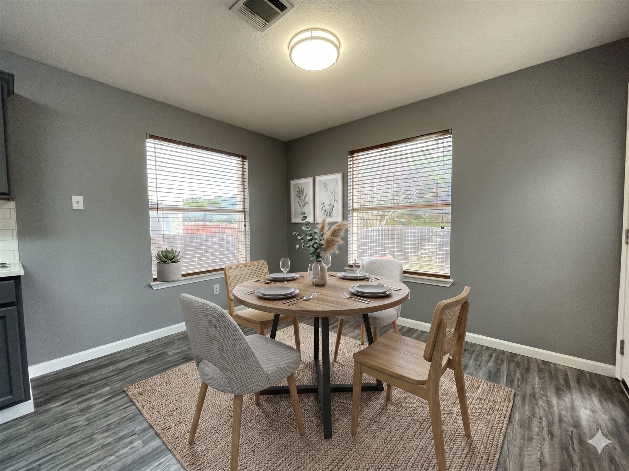 3638 Windhill Loop Round Rock, TX 78681 - Photo 3 of 32 Dining area featuring two windows with horizontal blinds, wood-finish flooring, and a ceiling-mounted light fixture