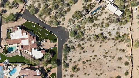 an aerial view of residential houses with outdoor space