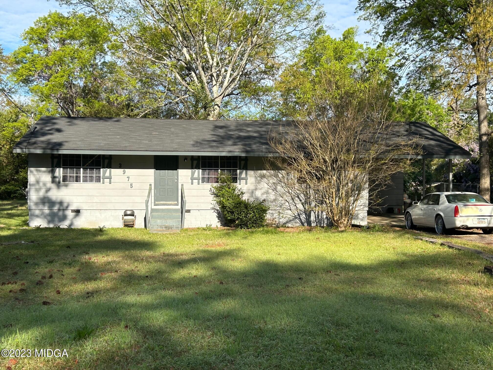 3975 Guyton Street Macon, GA 31206 - Photo 1 of 1 a view of a yard with a house and large trees