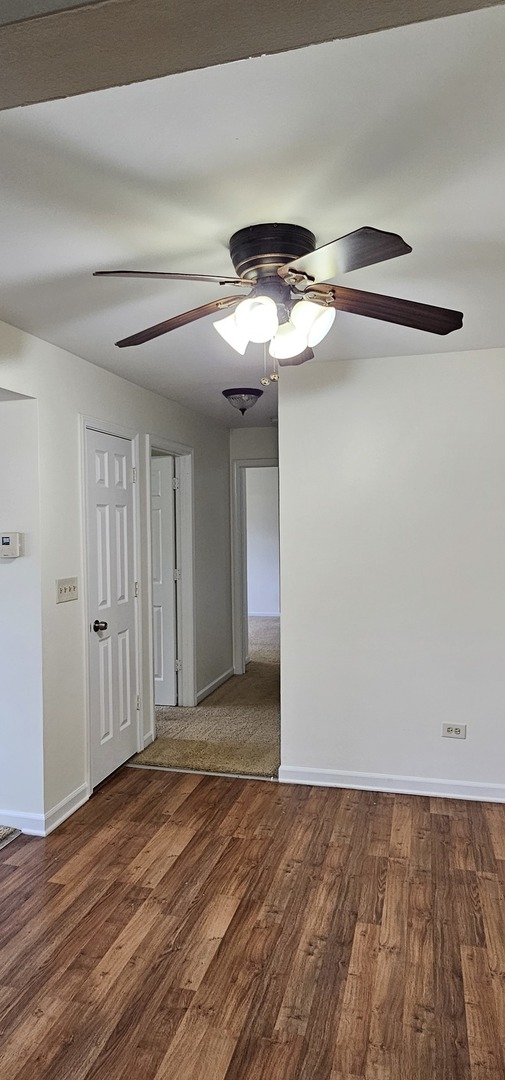 833 Village Quarter Road, Unit A3 West Dundee, IL 60118 - Photo 15 of 27 a view of an empty room with wooden floor
