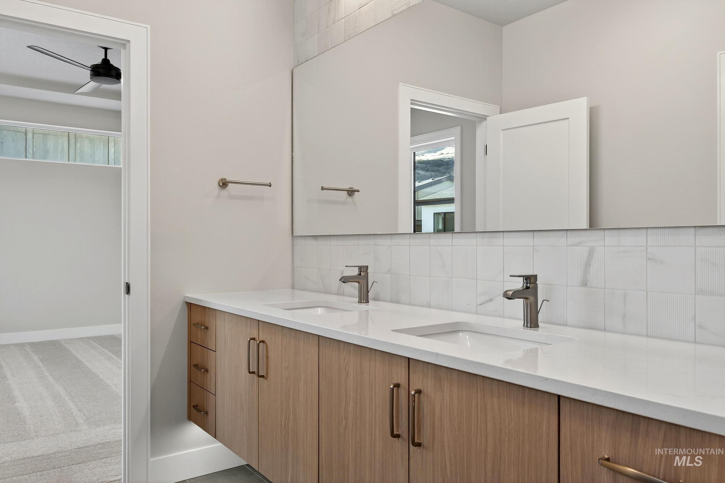 3374 West Neville Rnch Drive Boise, ID 83714 - Photo 23 of 37 Bathroom featuring backsplash, double vanity, ceiling fan, and light colored carpet
