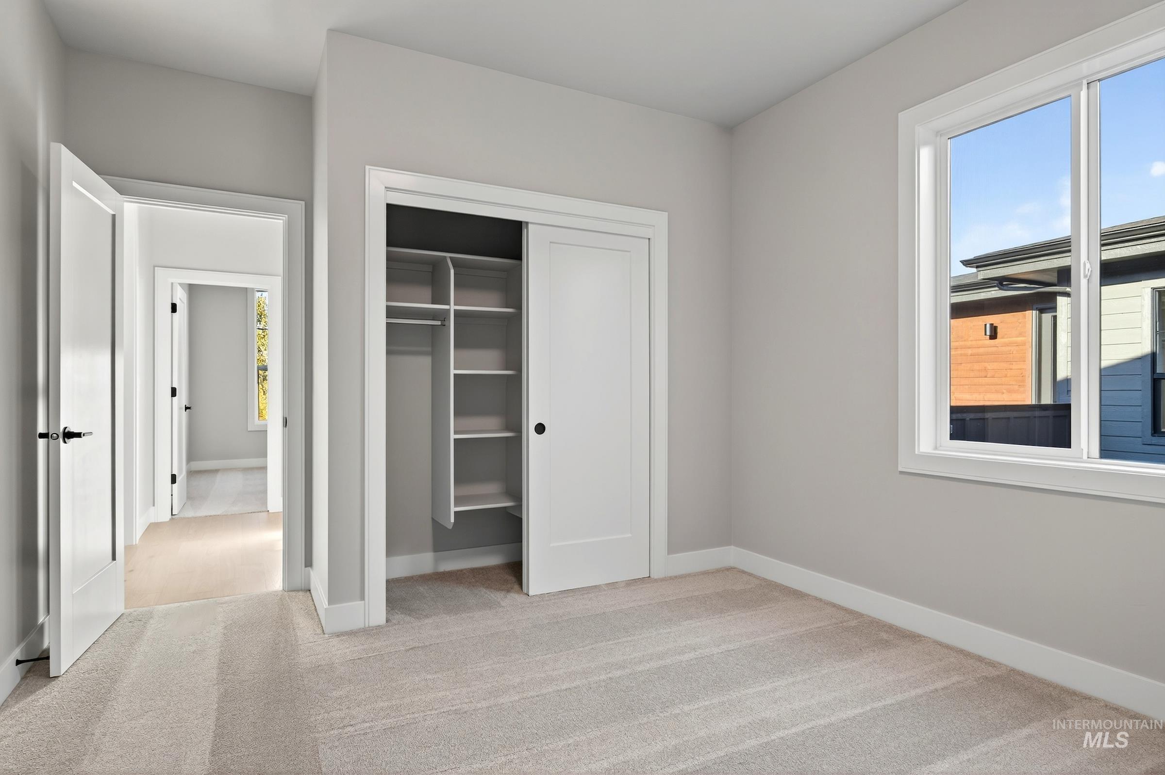3374 West Neville Rnch Drive Boise, ID 83714 - Photo 33 of 37 Unfurnished bedroom with light colored carpet and a closet