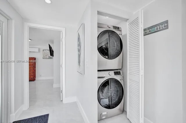 a view of a hallway with washer and dryer