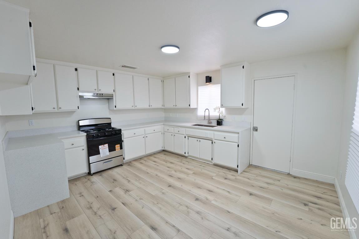 Undisclosed Address Wasco, CA 93280 - Photo 11 of 12 a kitchen with white cabinets and appliances