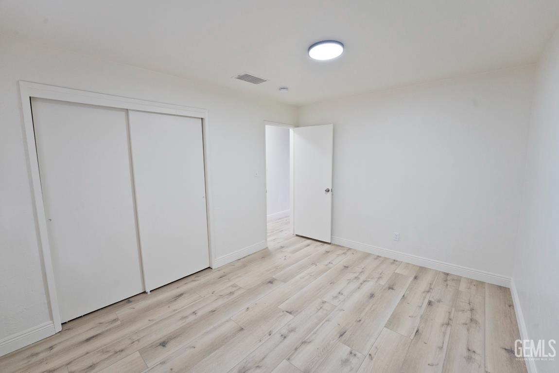 Undisclosed Address Wasco, CA 93280 - Photo 2 of 12 a view of an empty room with wooden floor
