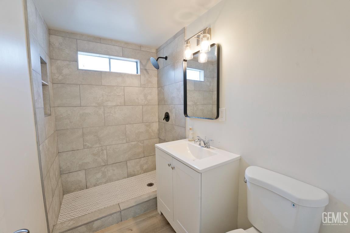 Undisclosed Address Wasco, CA 93280 - Photo 4 of 12 a bathroom with a sink a toilet and shower