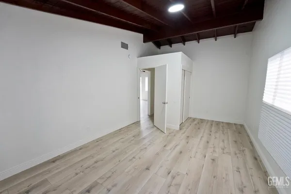 a view of a room with wooden floor and window