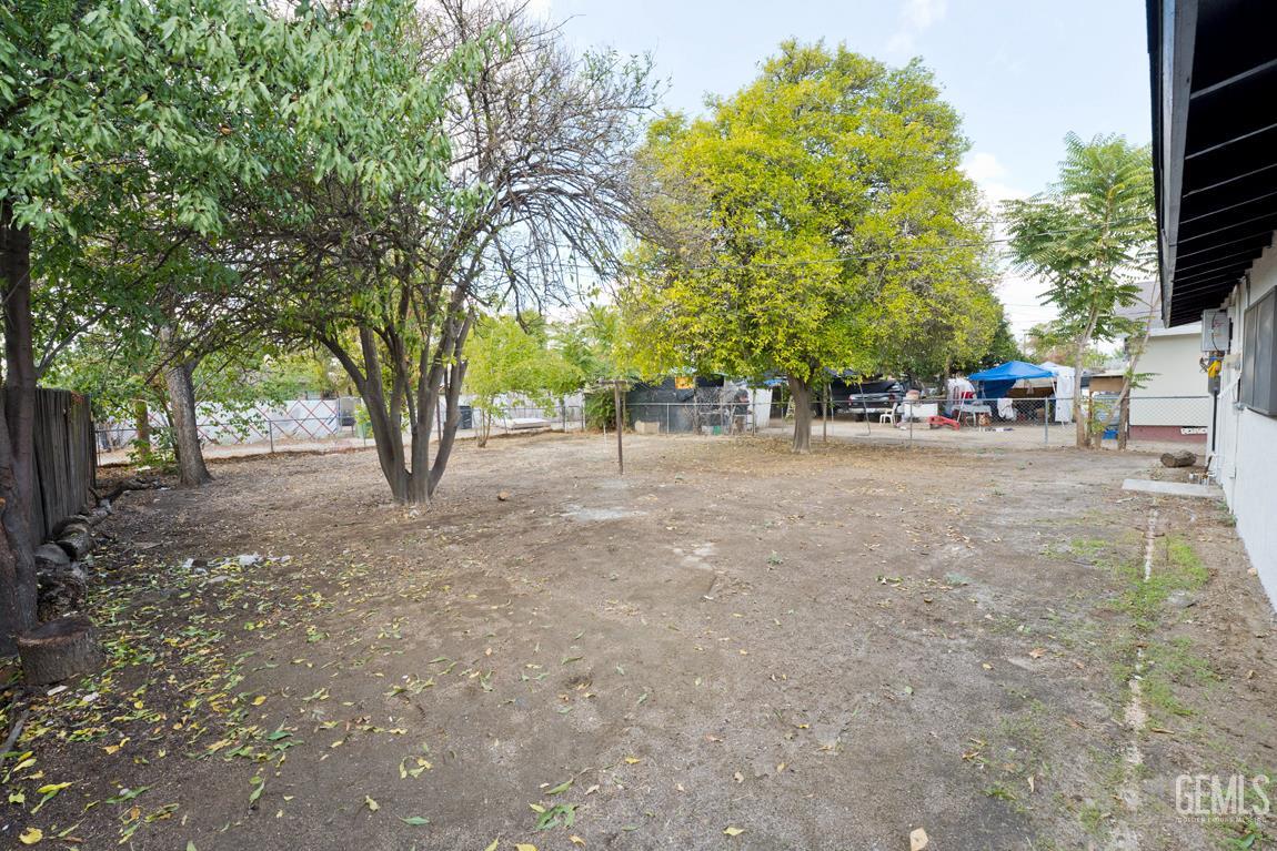 Undisclosed Address Wasco, CA 93280 - Photo 7 of 12 a view of a street with trees and houses