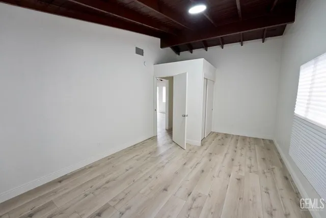 a view of a room with wooden floor and window