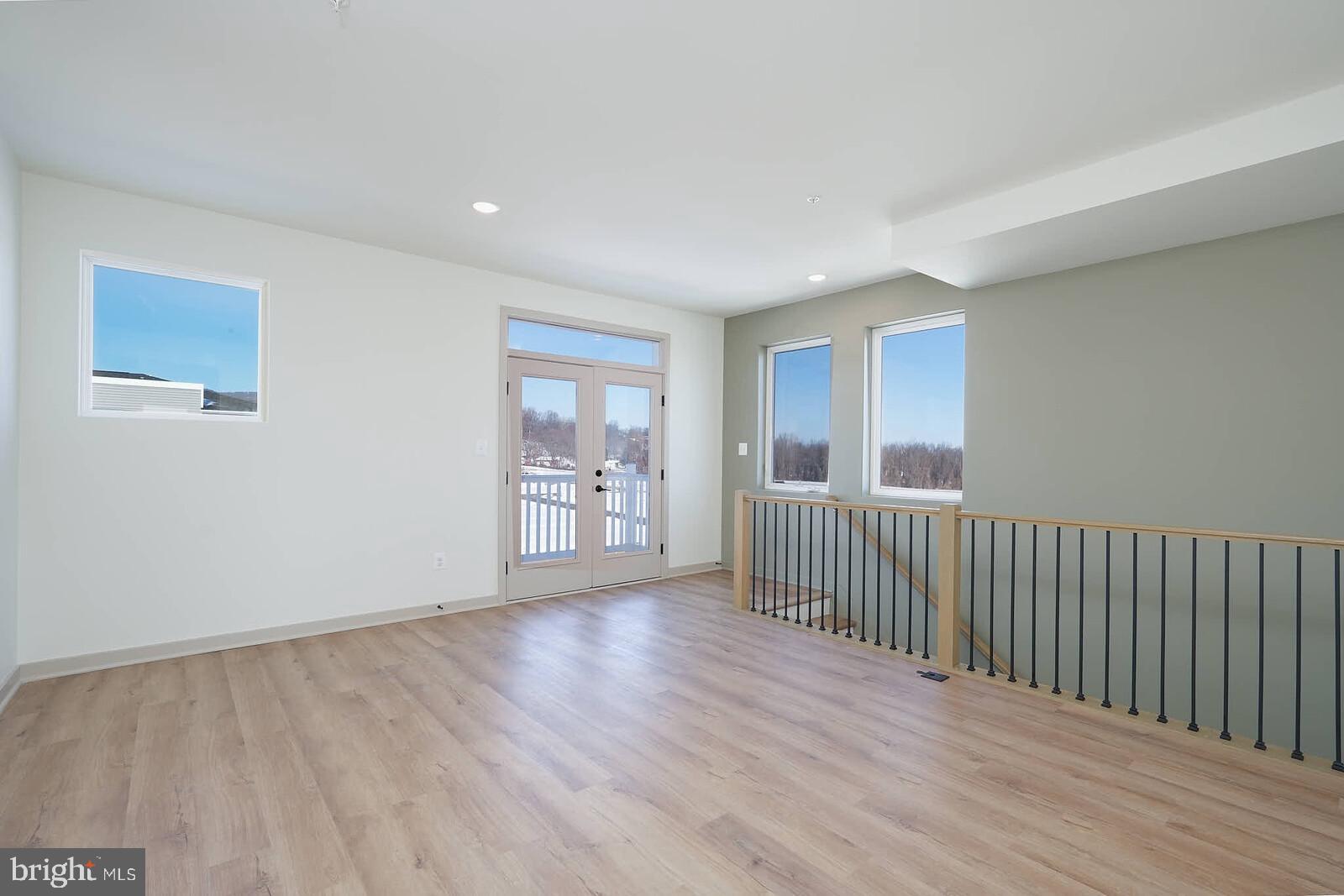 710 D Iron Frg Road Frederick, MD 21702 - Photo 24 of 43 a view of a big room with wooden floor and windows