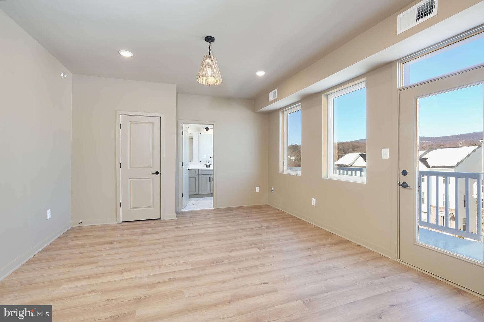 710 D Iron Frg Road Frederick, MD 21702 - Photo 25 of 43 a view of an empty room with wooden floor and a window