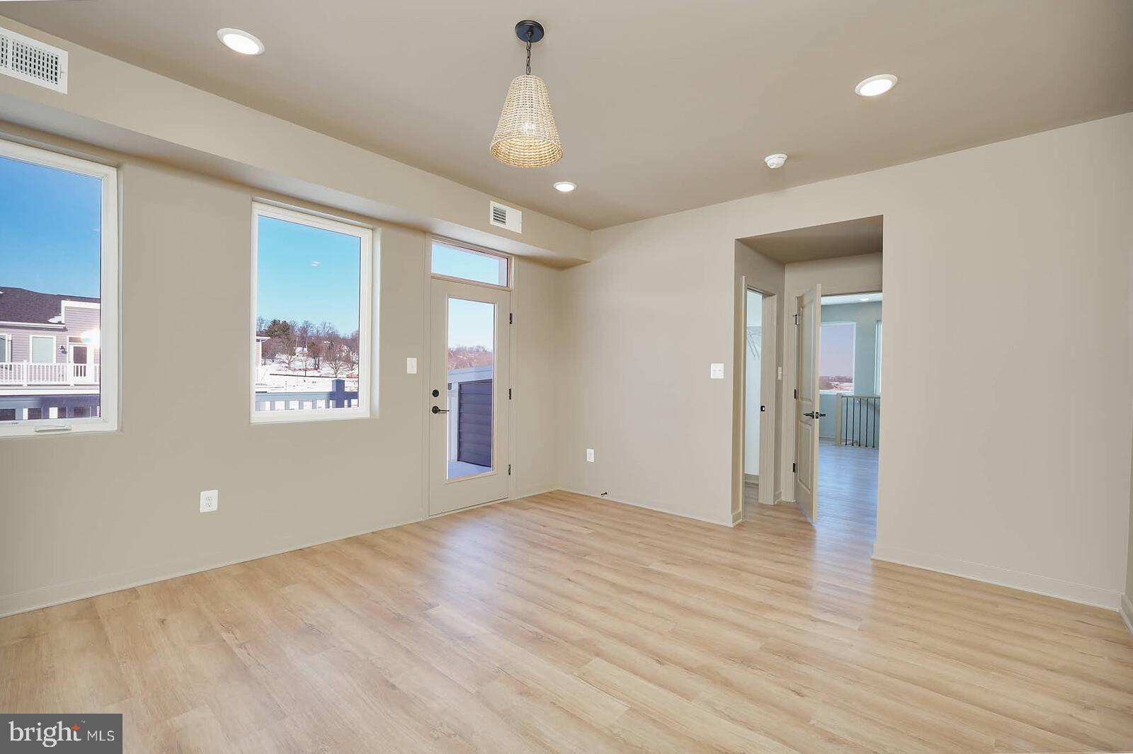 710 D Iron Frg Road Frederick, MD 21702 - Photo 26 of 43 an empty room with wooden floor and windows