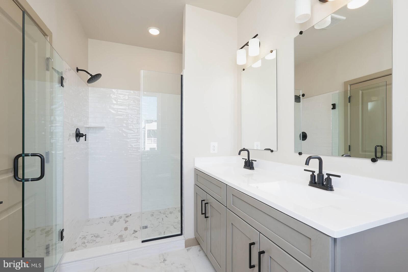 710 D Iron Frg Road Frederick, MD 21702 - Photo 30 of 43 a bathroom with a shower sink vanity and mirror