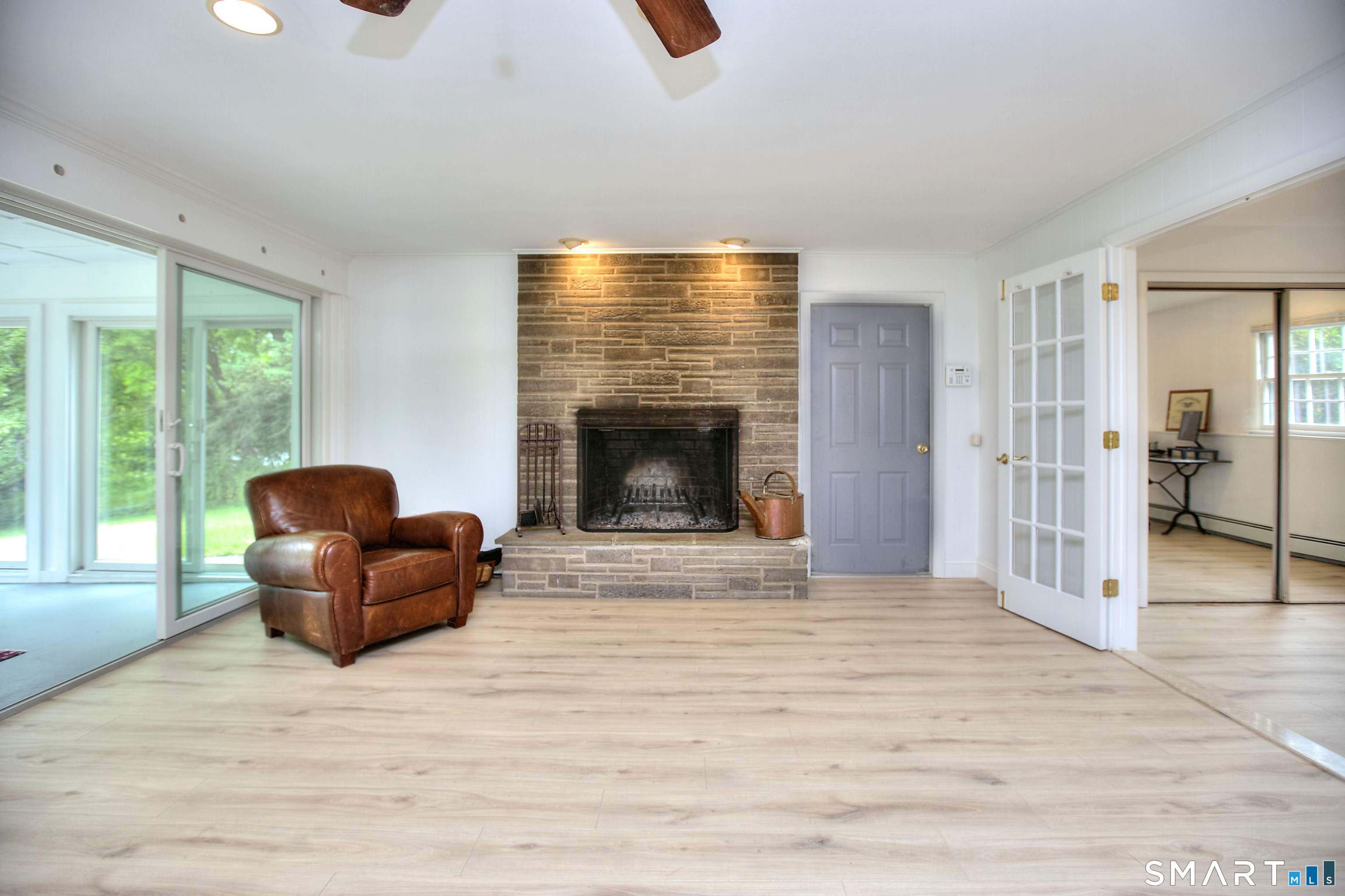 324 Ridge Road Orange, CT 06477 - Photo 17 of 38 a living room with furniture and a fireplace