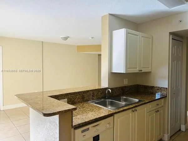 a kitchen with a refrigerator sink stove and cabinets