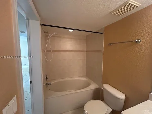 a bathroom with a shower and a sink