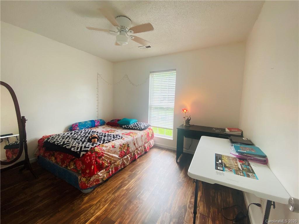 7121 Rena Mae Lane Charlotte, NC 28227 - Photo 11 of 21 a bedroom with a bed and a dresser in it