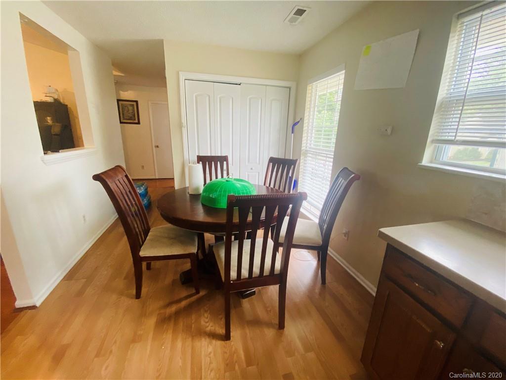 7121 Rena Mae Lane Charlotte, NC 28227 - Photo 17 of 21 a view of a dining room with furniture and wooden floor