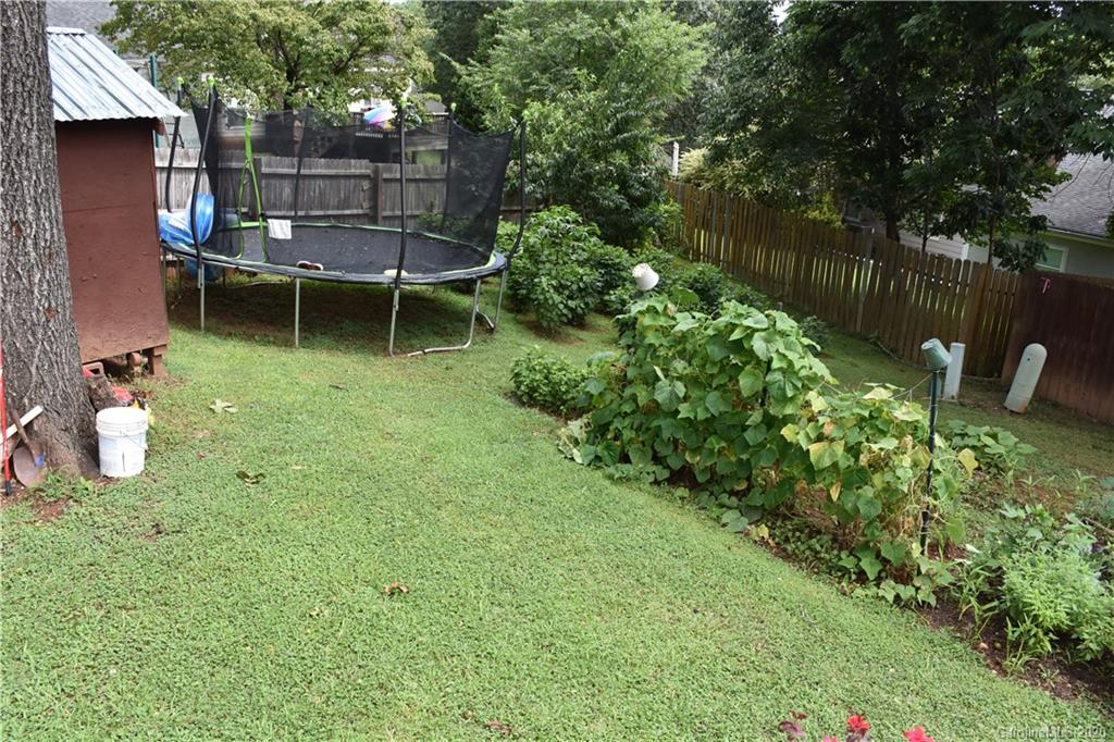 7121 Rena Mae Lane Charlotte, NC 28227 - Photo 18 of 21 a view of a backyard with chairs potted plants and a fountain